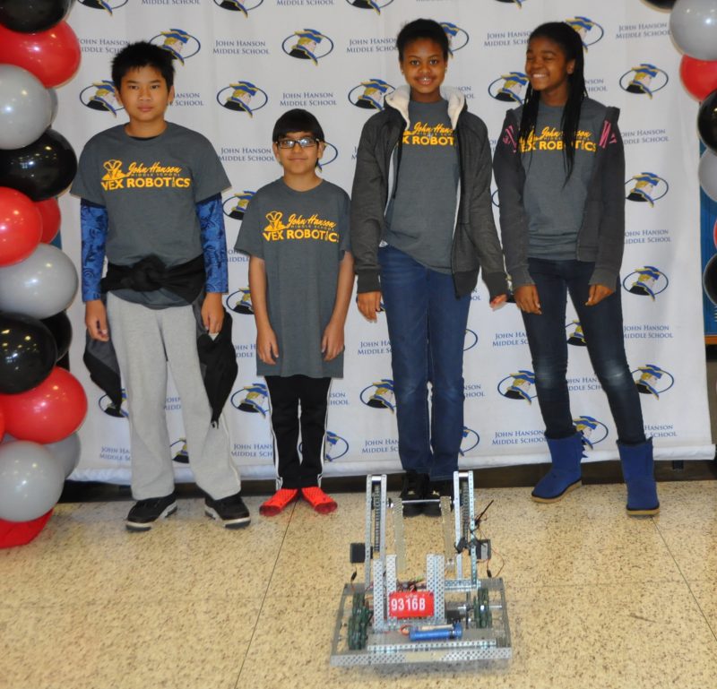 John Hanson Middle School seventh graders Kritchanin Yampai, left, Parth Madaan, Sydney Lewis and Gaciella Ndjampa are members of the school’s Pro Vex Masters team which won the Judge’s Award at the VEX Robotics Competition Feb. 4 at the College of Southern Maryland. Daniel Meltsner, technology education teacher, is the coach of Hanson’s four VEX Robotics teams. 