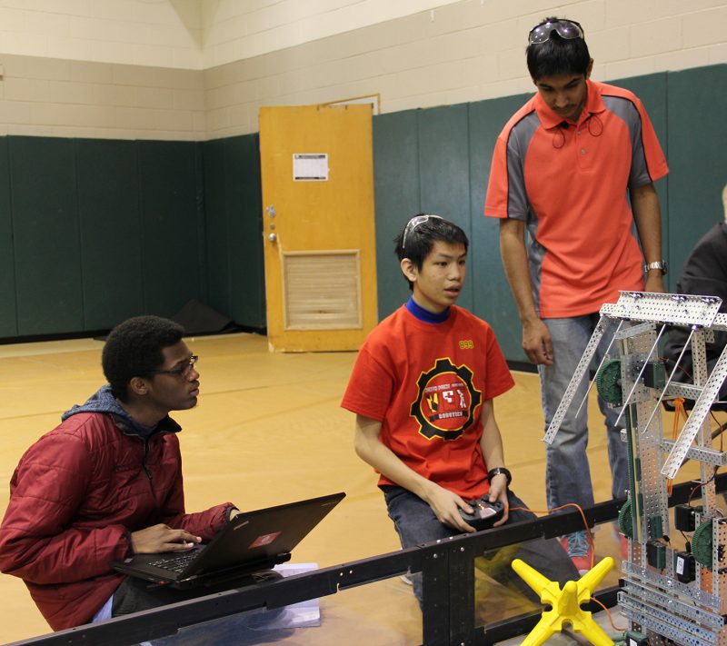 North Point High School students junior Jabari Grubb, left, sophomore Andrew Fan and junior Zaahid Ramakdawala confer about their robot during the Feb. 4 VEX Robotics competition at the College of Southern Maryland. 