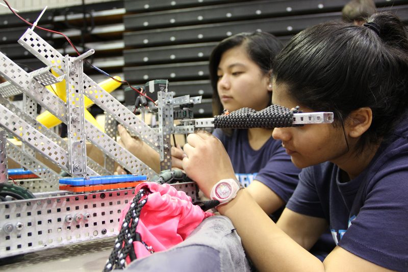 Members of La Plata High School’s VEX Robotics team, Angle Warriors, sophomores Emily DePew, left, and Sophia Khan, work on their robot before the competition started Feb. 4 at the College of Southern Maryland. 