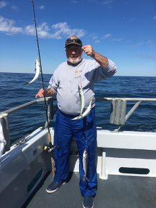 A lucky angler with 4 mackerel caught at once. Courtesy of Capt. Monty Hawkins.