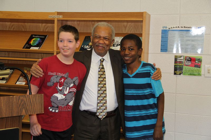 Rev. Reginald Green, center, greets Theodore G. Davis Middle Schools seventh graders David Hemsley, right, and Brock Boles, left, after he speaks with students about his experiences as Freedom Rider during the civil rights movement in the 1960s. Green was invited to Davis by social studies teacher Duania Darby to talk with her classes about the civil rights movement as part of their unit on Black History Month. 