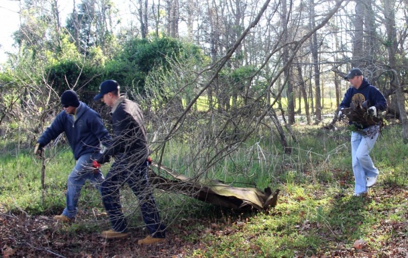 Volunteers from Naval Air Station Patuxent River remove rusted fencing and trash during a community relations project at Newtowne Neck State Park in southern Maryland. The Sailors joined other volunteers from around the community to help clean up a 4-acre area of the park that has been designated as a future nature walk.