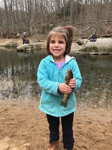 This youngster is all smiles with her first trout on the Little Gunpowder while fishing with her dad. Courtesy of David Richard.