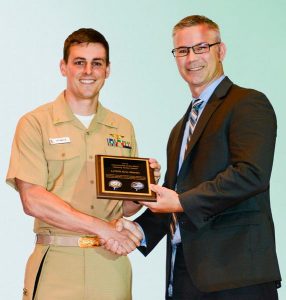 Lt. Cmdr. Eric Martin accepts the Department of the Navy (DON) Aspiring Tester Award from DON Deputy for Test and Evaluation Carroll P.