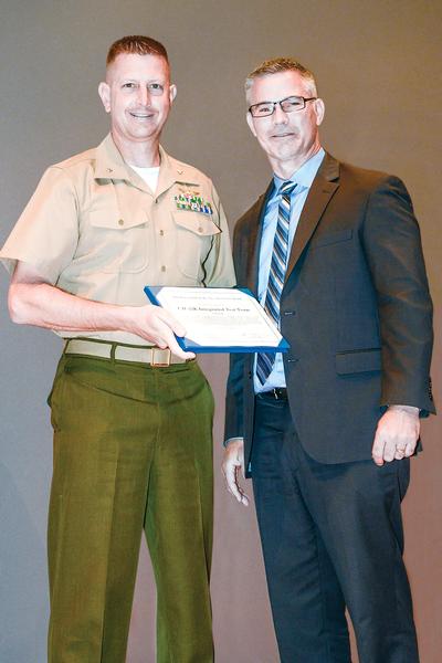 On behalf of the CH-53K King Stallion Integrated Test Team, Lt. Col. John Ennis, government flight test director for the CH-53K, accepts the Department of the Navy (DON) Test Team Award from DON Deputy for Test and Evaluation Carroll P. "Rick" Quade during a May 24 ceremony at Patuxent River Naval Air Station, Md. The team was recognized for overcoming several major technical obstacles during its first year of flight test. (U.S. Navy photo)