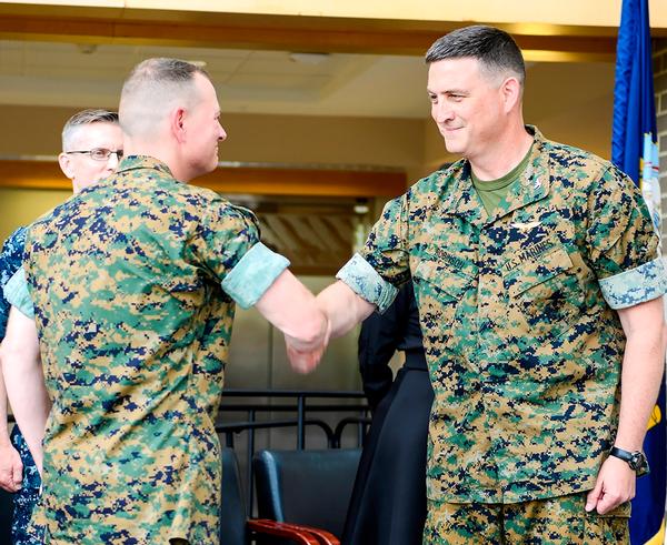 Outgoing program manager Col. Dan Robinson (right) shakes hands with the incoming program manager Col. Matthew Kelly (left) as Robinson relinquishes command of the V-22 Joint Program Office (PMA-275) in a ceremony July 5 at the Naval Air Systems Command, NAS Patuxent River, Md. (U.S. Navy Photo)