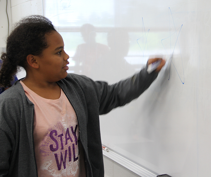 Laila Manley, a sixth grader at John Hanson Middle School, has an easy go of it during Pictionary during Fun in the Sun STEM camp at the James E. Richmond Science Center. Her clue was “stars.” 