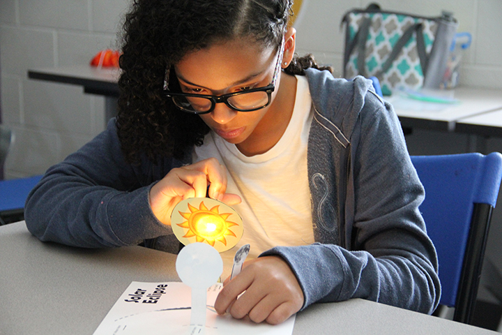 Isabella Brown, a seventh grader at Theodore G. Davis Middle School, works on her project illuminating how a solar eclipse works. Brown and other area students attended the Fun in the Sun camp at the James E. Richmond Science Center. 