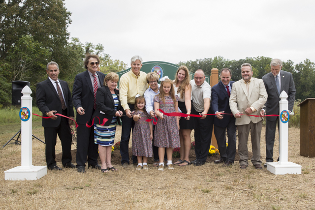 The Charles County Commissioners join with Director of Recreation, Parks, and Tourism Eileen Minnick, Tom Roland and his family, Secretary of the Maryland Department of Natural Resources Mark J. Belton, and Chief of Parks and Grounds John Snow.