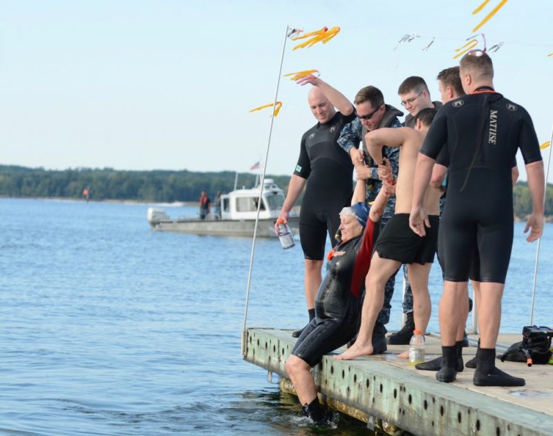 Diane Sherkow, NAS Patuxent River educational services officer, is pulled out of the Patuxent River by other swimmers after the 2017 NAS Patent River Search and Rescue (SAR) Swim. Sherkow and six other swimmers, mostly from Pax River's SAR team, swam 1.7 miles across the Patuxent River in the annual event.