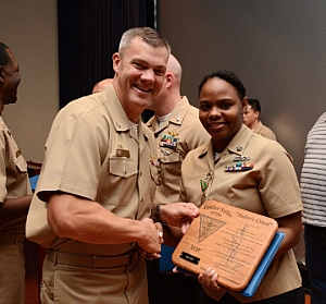 Capt. Jason Hammond, NAS Patuxent River commanding officer, presents the 2017 Junior Sailor of the Year plaque to Culinary Specialist 2nd Class Iesha Jolly during an awards presentation at NAS Patuxent River. Jolly serves as the Unaccompanied Housing Building Manager, responsible for the maintenance and upkeep of seven barracks buildings, totaling 233 rooms.