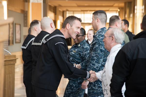 Petty Officer 1st Class Michael A. Giraud, NAVAIR’s 2017 Sailor of the Year, accepts congratulations from Ronnie Burdett following the award ceremony. (U.S. Navy photo)