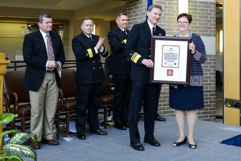 NAVAIR Commander Vice Adm. Paul Grosklags congratulates Ruth Perry, far right, who is retiring after coordinating the Commander’s Awards and all other honorary awards for seven years. 