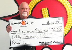 Charles County’s Gene Shontere, Jr. collects his $50,000 Powerball prize.