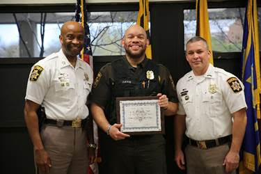 CFC Al Davis, center, receives the 2018 Correctional Officer of the Year Award from Sheriff Troy Berry and CCDC Director Brandon Foster