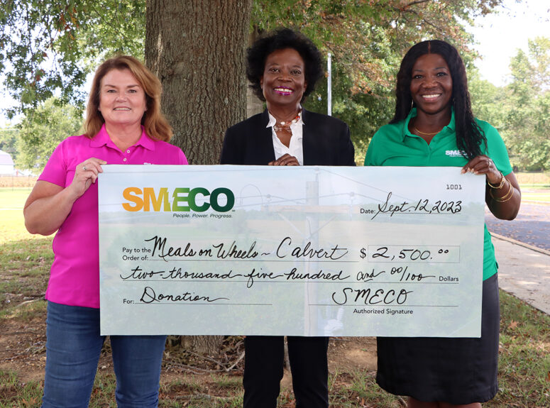 Shirl Hendley, president, Calvert County Meals on Wheels, receives a check for $2,500 from Sonja Cox, SMECO president and CEO (left) and Natalie Cotton, SMECO government affairs and community relations director (right).