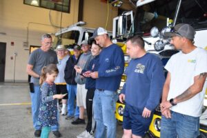 Lion Cub Harper passing out Thank You cards to members of Bay District Volunteer Fire Department
