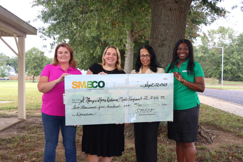 Sonja Cox, SMECO president and CEO (left) and Natalie Cotton, SMECO government affairs and community relations director (right) presents a check to Danielle Manalansan and Lori Jennings-Harris, St. Mary’s County Home Delivered Meals Program.